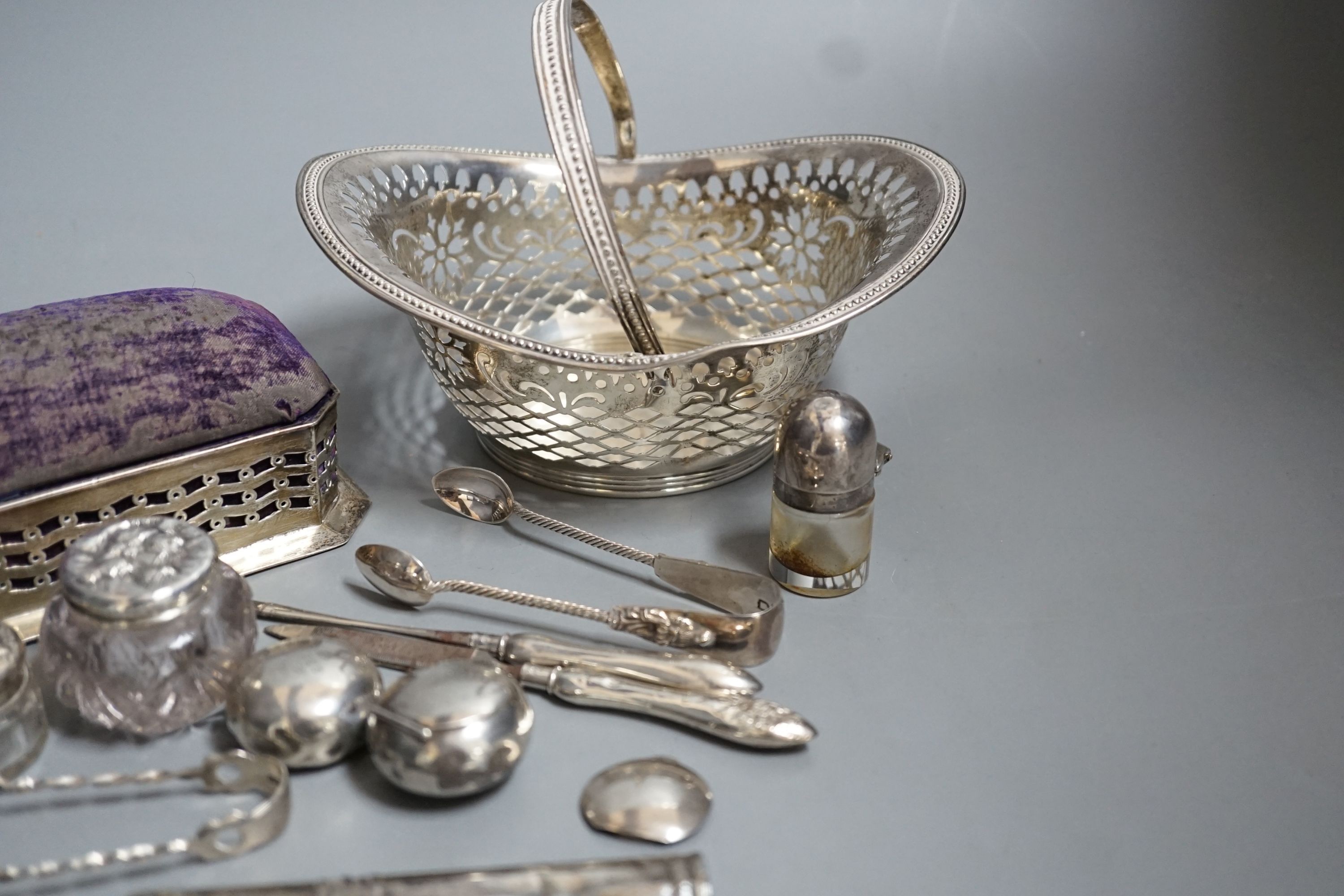 Small silver including two pill boxes, a silver mounted pin cushion, a sterling bonbon basket, etc.